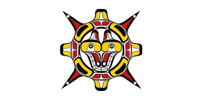 The logo shows a wolf’s head in the Pacific Northwest Coast Indigenous art style. It’s coloured red, yellow, and black. The wolf is inside a decorated circle of the same colours and style.